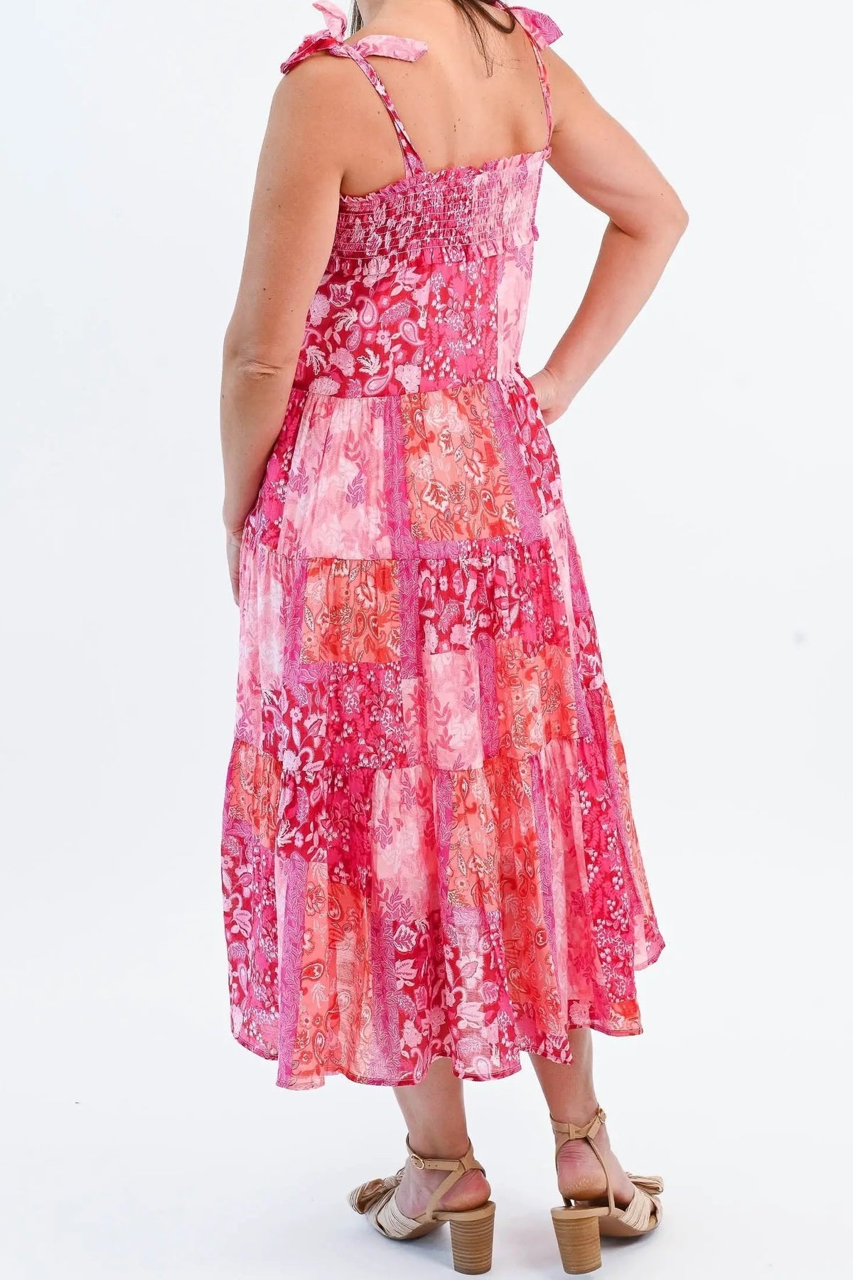 Back of the pink patchwork midi dress, showing the smocked back, tie straps and tiered skirt