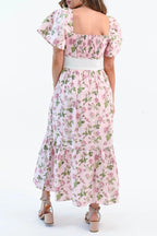 Back of the pink rose print dress, showing the smocked square back, flutter sleeves and cream bow belt