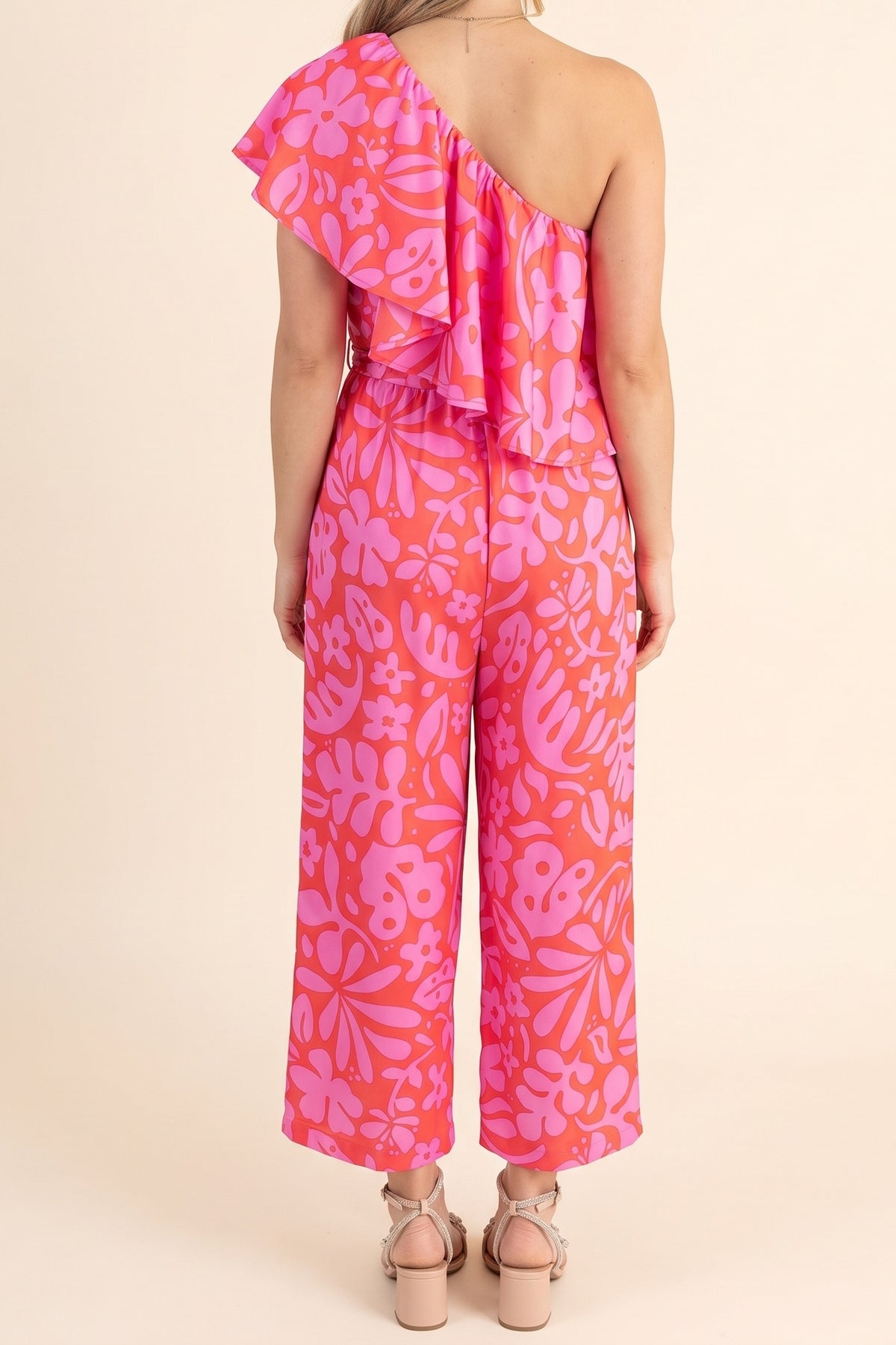Kiss Me Again Coral One Shoulder Ruffle Cropped Jumpsuit, back view of the one-shoulder ruffle