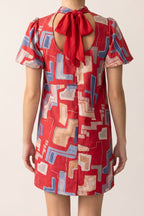 Bold Statement Bubble Sleeve Tie Back Dress, back view showing the keyhole and red tie bow