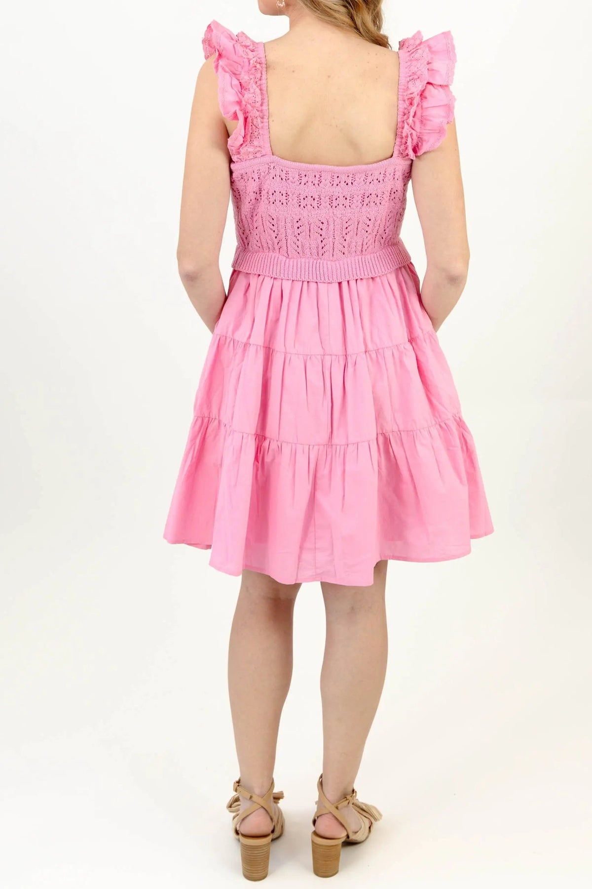 Back of the light pink crochet dress, showing the low square back, ruffled straps and tiered skirt above the knee