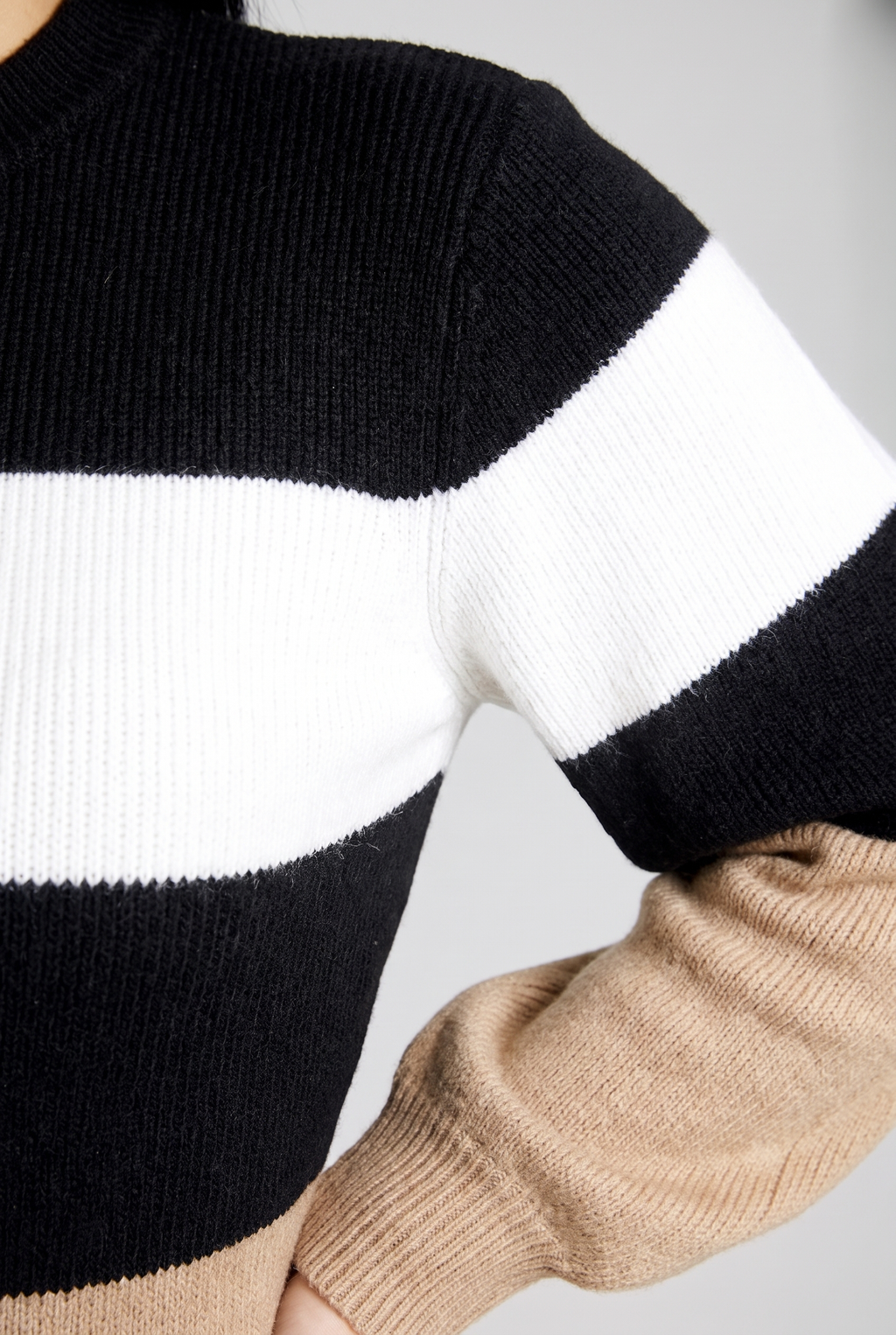 Close-up of the Maverick sweater dress's knit where the colour blocks meet