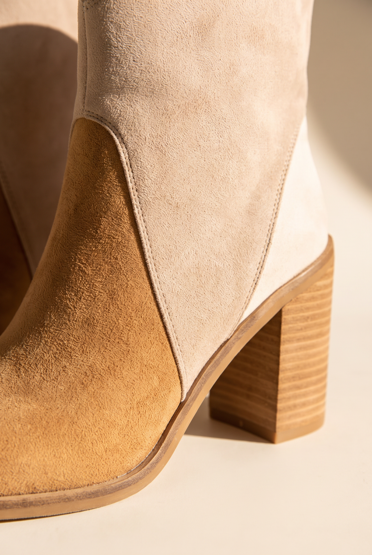 Close-up of the Sadie bootie's suede panels, stitching and heel