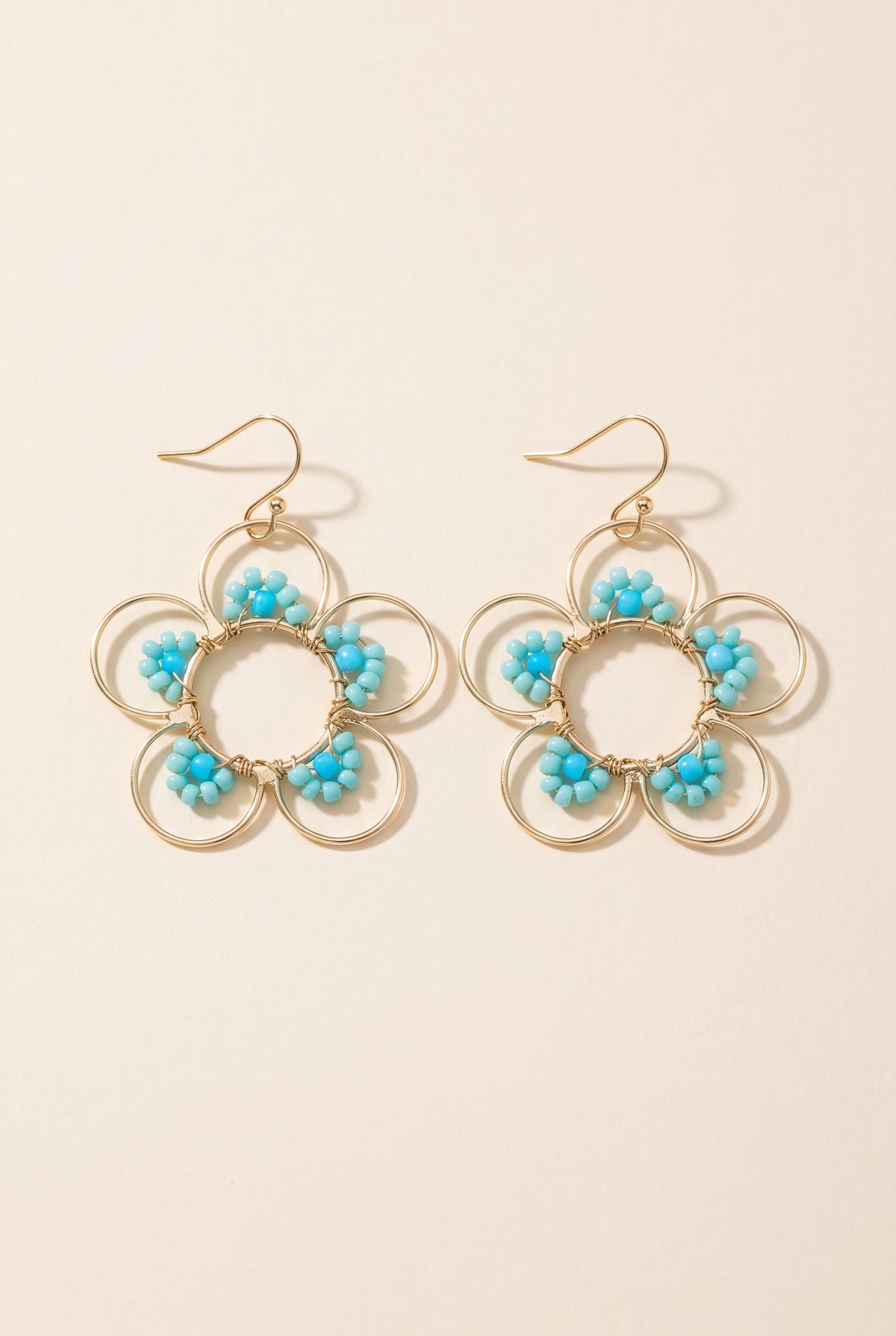 Daisy Earrings in Blue: open gold wire flowers with turquoise seed beads on gold fish-hook ear wires
