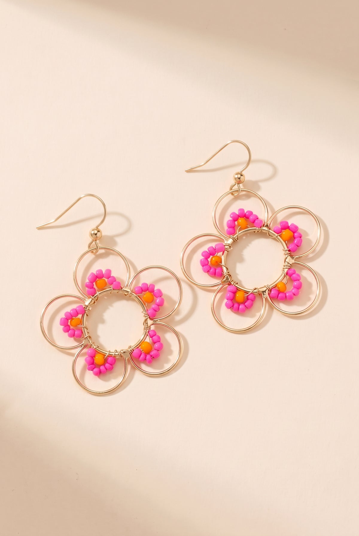 Daisy Earrings in Hot Pink: open gold wire flowers with hot pink seed beads and orange accent beads on gold fish-hook ear wires