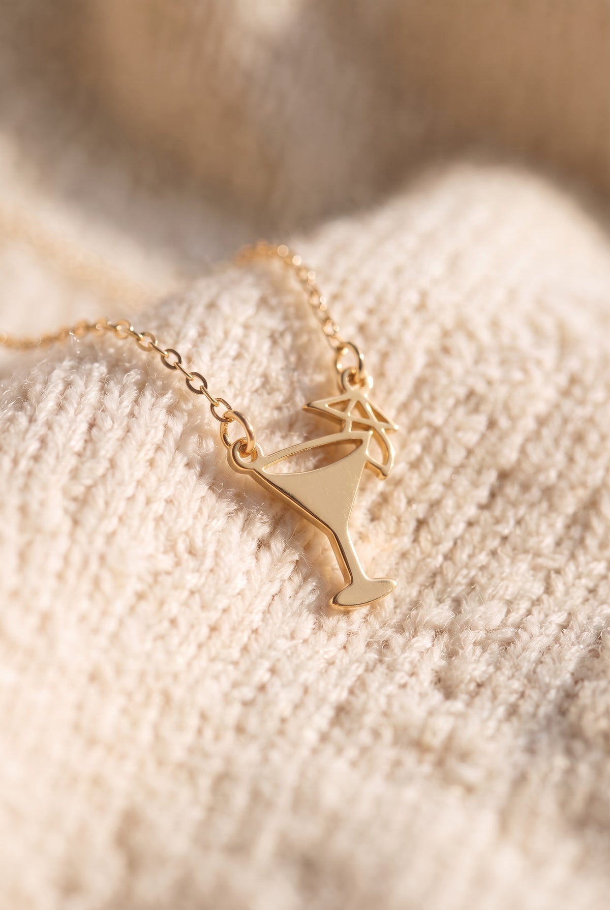 Emily Margarita Time Necklace close-up: gold cocktail glass charm with an open bowl, straight stem and a tiny umbrella, on a fine cable chain