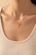 Emily Margarita Time Necklace worn at true size: a small gold cocktail glass charm on a fine chain, just below the collarbones
