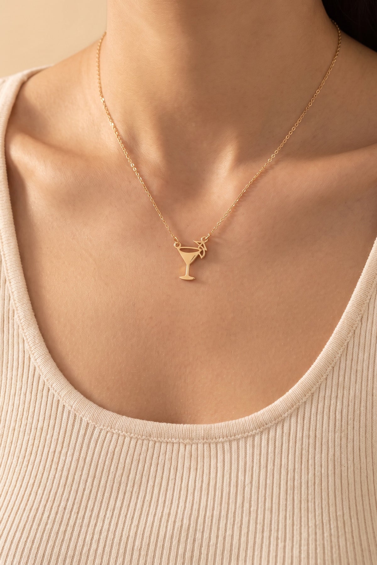 Emily Margarita Time Necklace worn at true size: a small gold cocktail glass charm on a fine chain, just below the collarbones