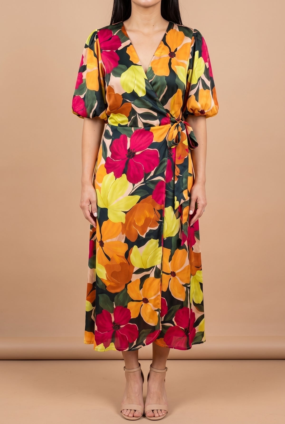 Front view of the If You're Not the One floral wrap midi dress on a beige studio backdrop, showing the V-neck wrap bodice, bubble sleeves, side tie and mid-calf hem.