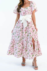 Front of the Sending You Love pink rose print dress, showing the square neckline, flutter sleeves, cream bow belt, front slit and ruffled hem at the lower calf