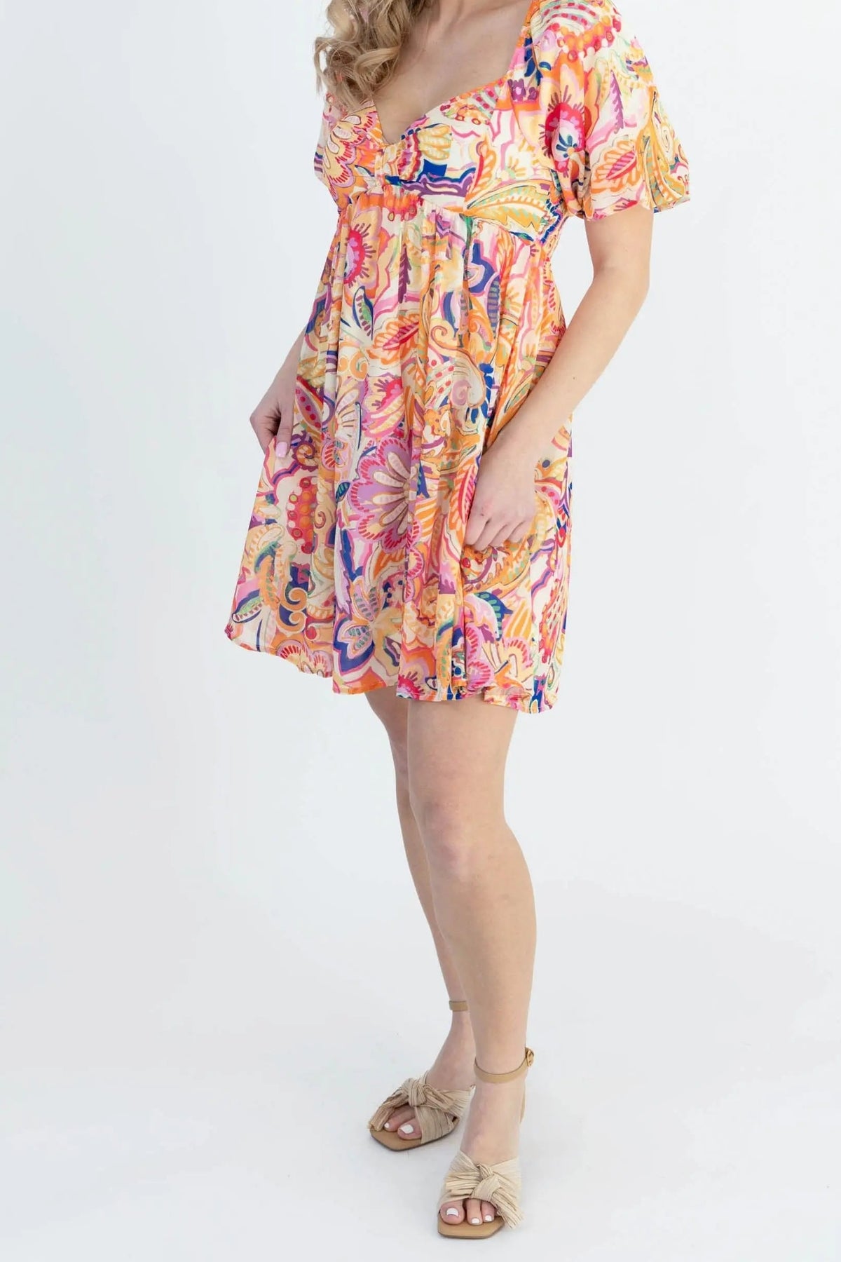 Front of the Create Your Sunshine mini dress, showing the sweetheart V neckline, puff sleeves, empire waist and swingy A-line skirt at mid-thigh