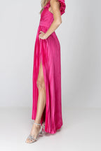 Side view of the One More Night maxi dress in Fuchsia, showing the rosette, pleats and leg slit