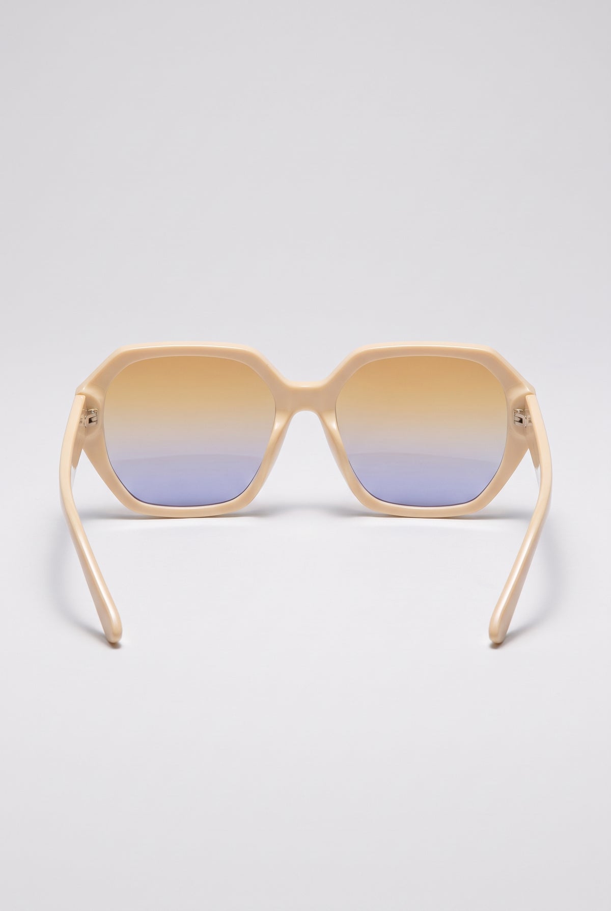 Haven oversized cream sunglasses seen from behind, showing the inside of the frame and the temples, on a light-grey backdrop