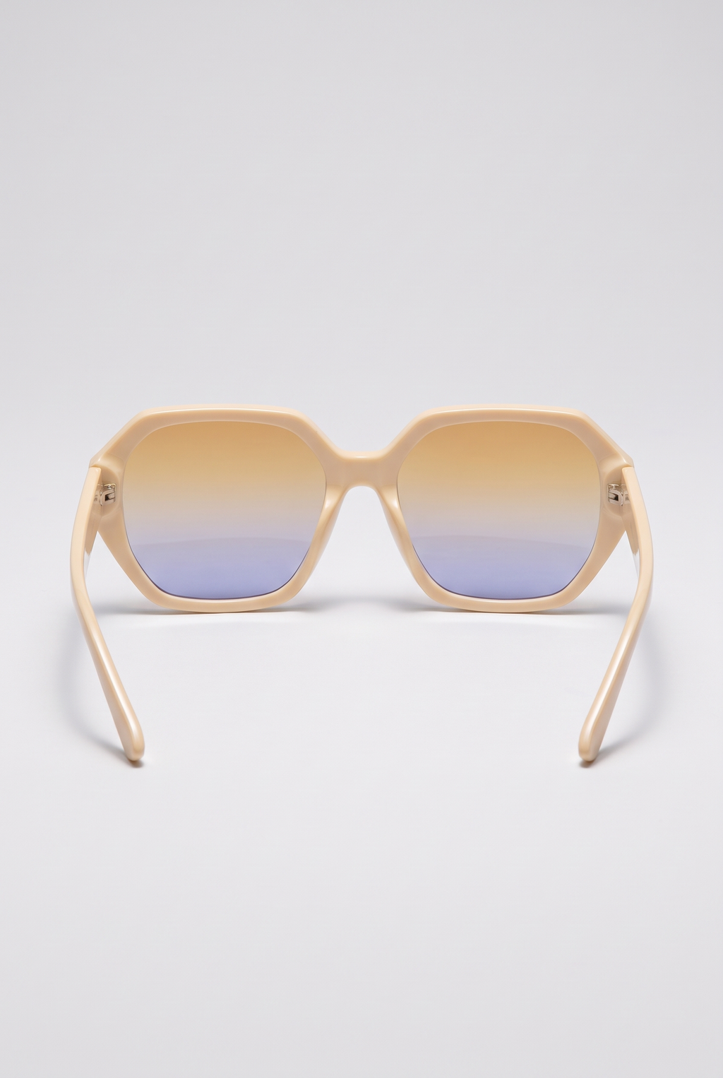 Haven oversized cream sunglasses seen from behind, showing the inside of the frame and the temples, on a light-grey backdrop