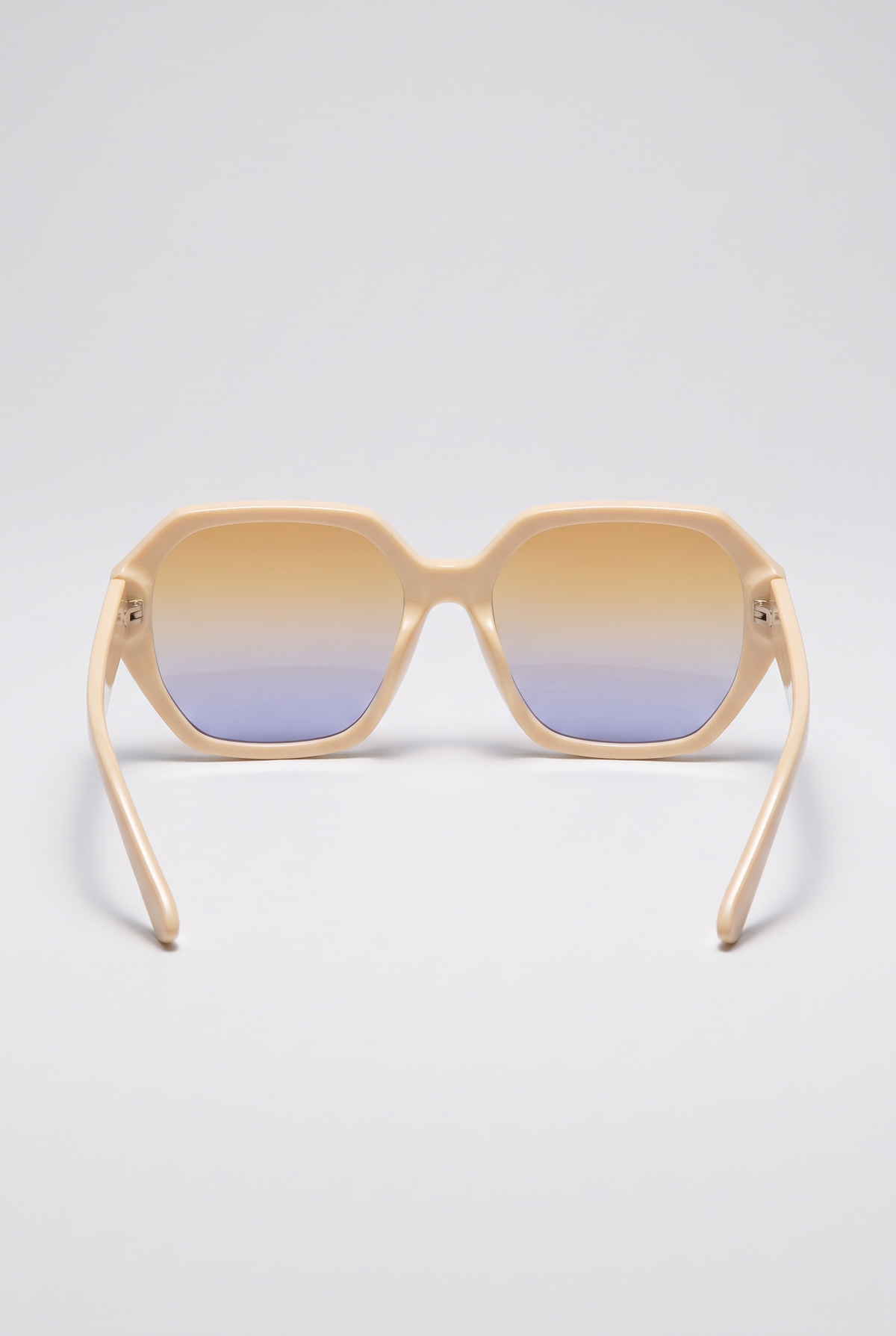 Haven oversized cream sunglasses seen from behind, showing the inside of the frame and the temples, on a light-grey backdrop