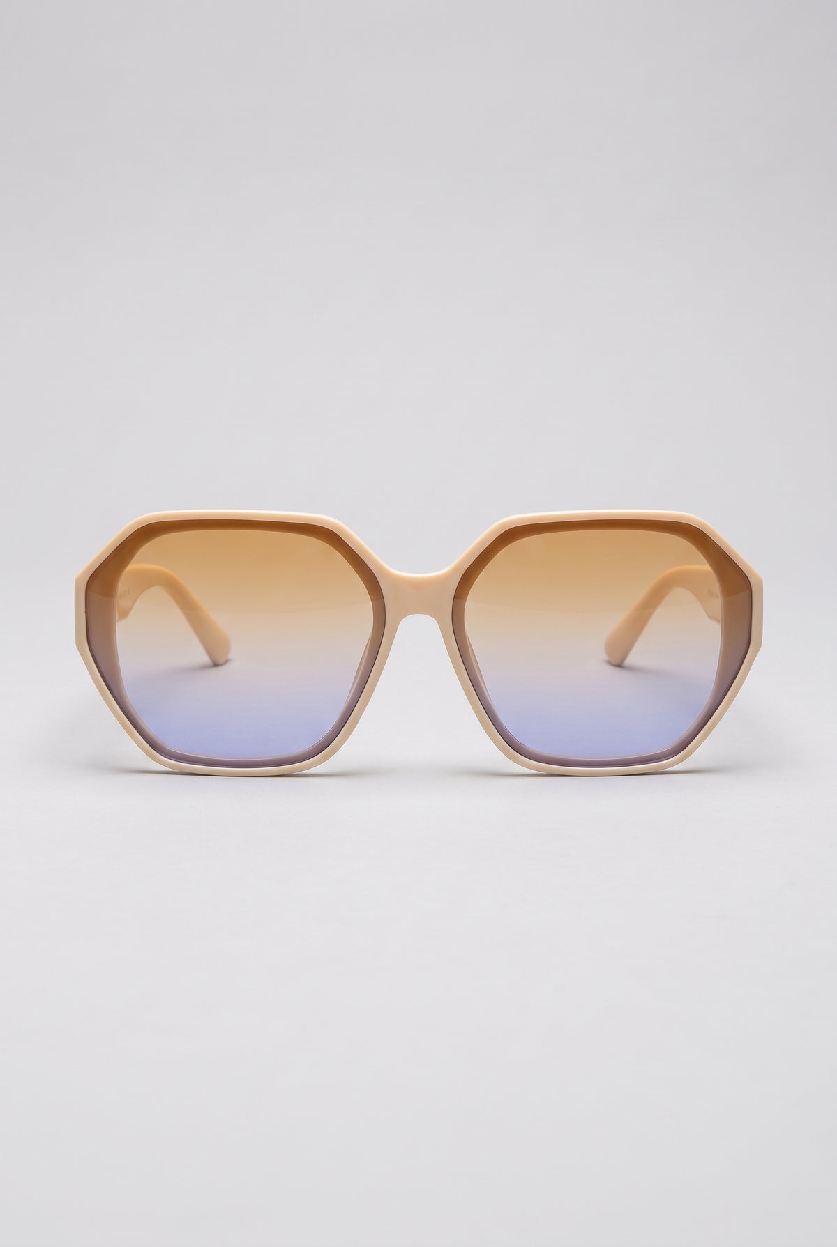 Haven oversized sunglasses in cream Coconut Cream frame with amber-to-blue gradient lenses, front view on a light-grey backdrop