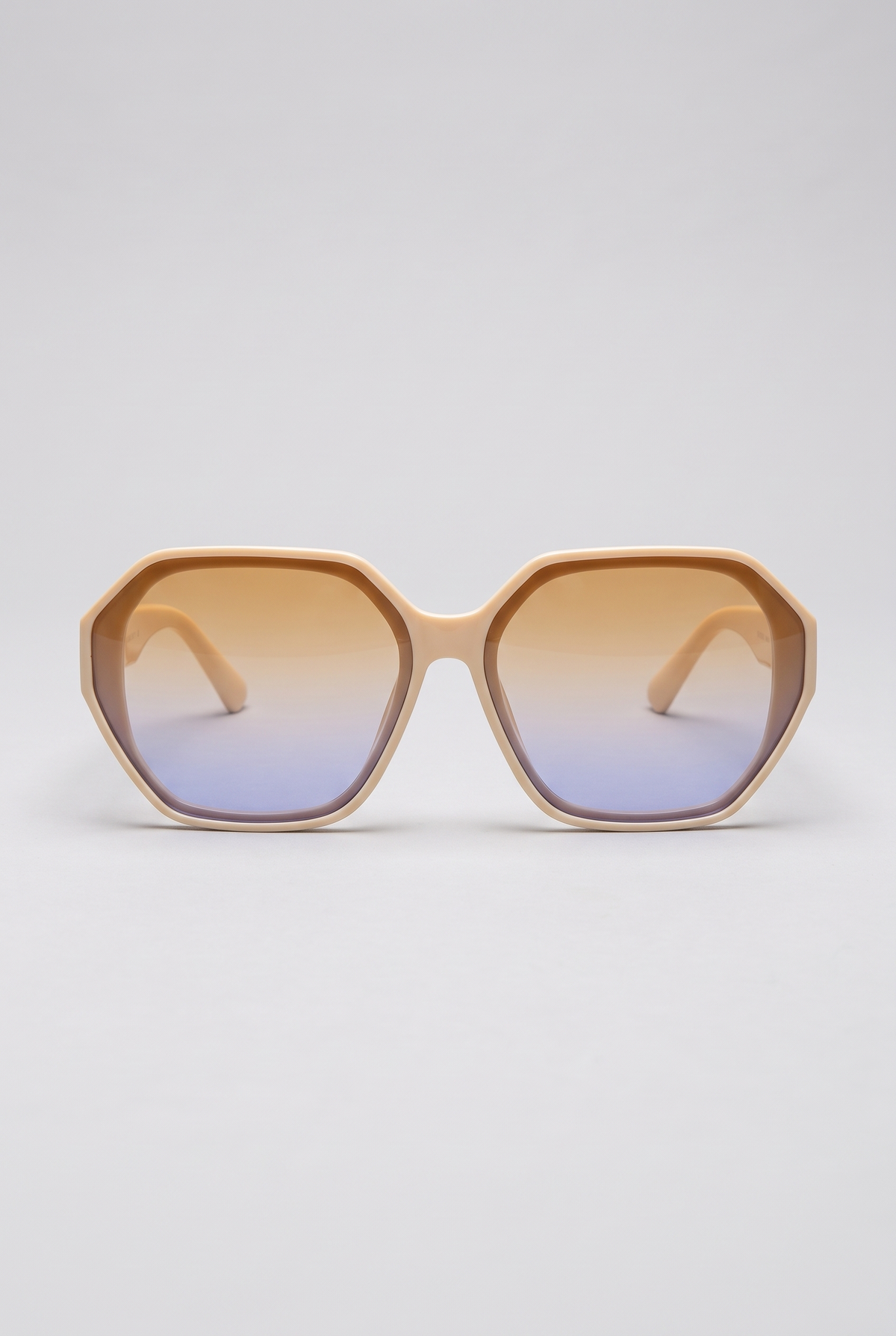 Haven oversized sunglasses in cream Coconut Cream frame with amber-to-blue gradient lenses, front view on a light-grey backdrop