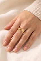 Maria Ocean Treasure Open Wrap Ring Gold worn on one finger, showing its true size: a small starfish and a small scallop shell on a slim gold band