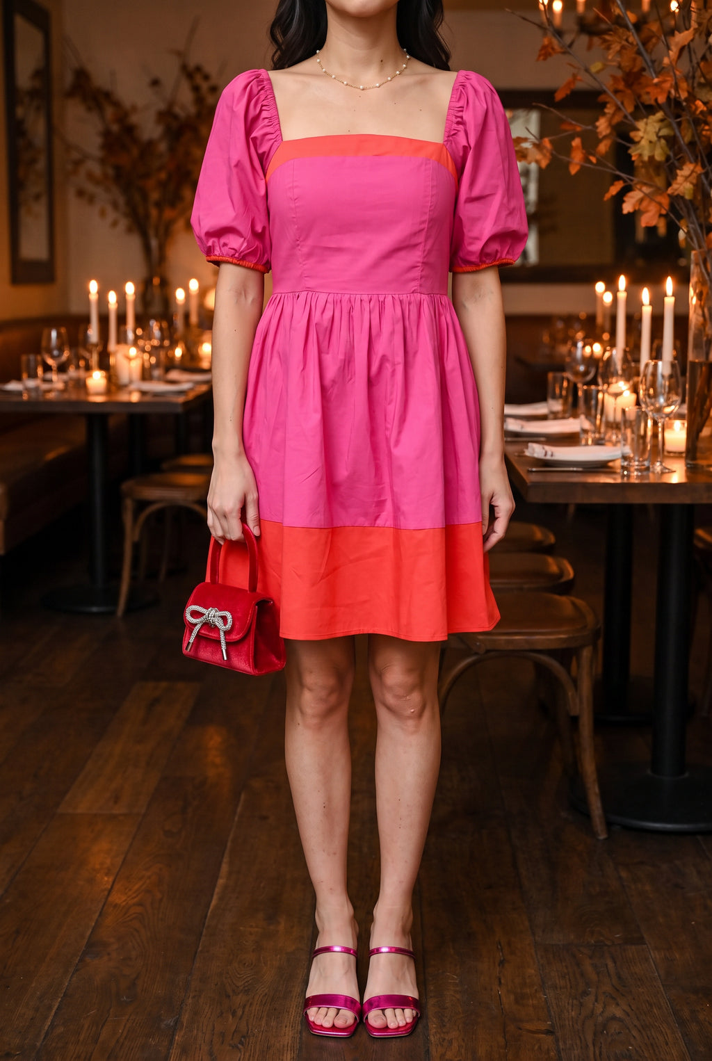 Magenta and red color block mini dress styled for a holiday dinner with metallic fuchsia square toe sandals, a red velvet top handle bag and a pearl chain necklace.