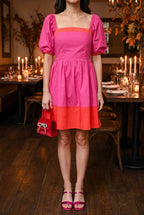 Magenta and red color block mini dress styled for a holiday dinner with metallic fuchsia square toe sandals, a red velvet top handle bag and a pearl chain necklace.