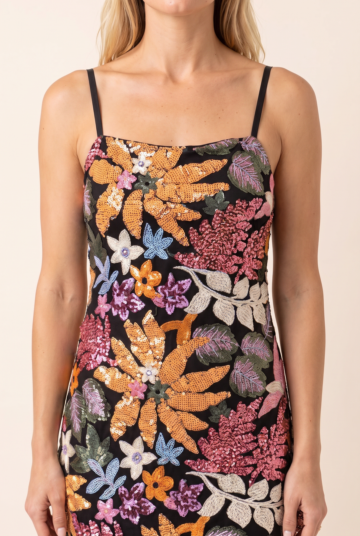 Close view of the sequin and bead florals on the black base, square neckline and thin straps