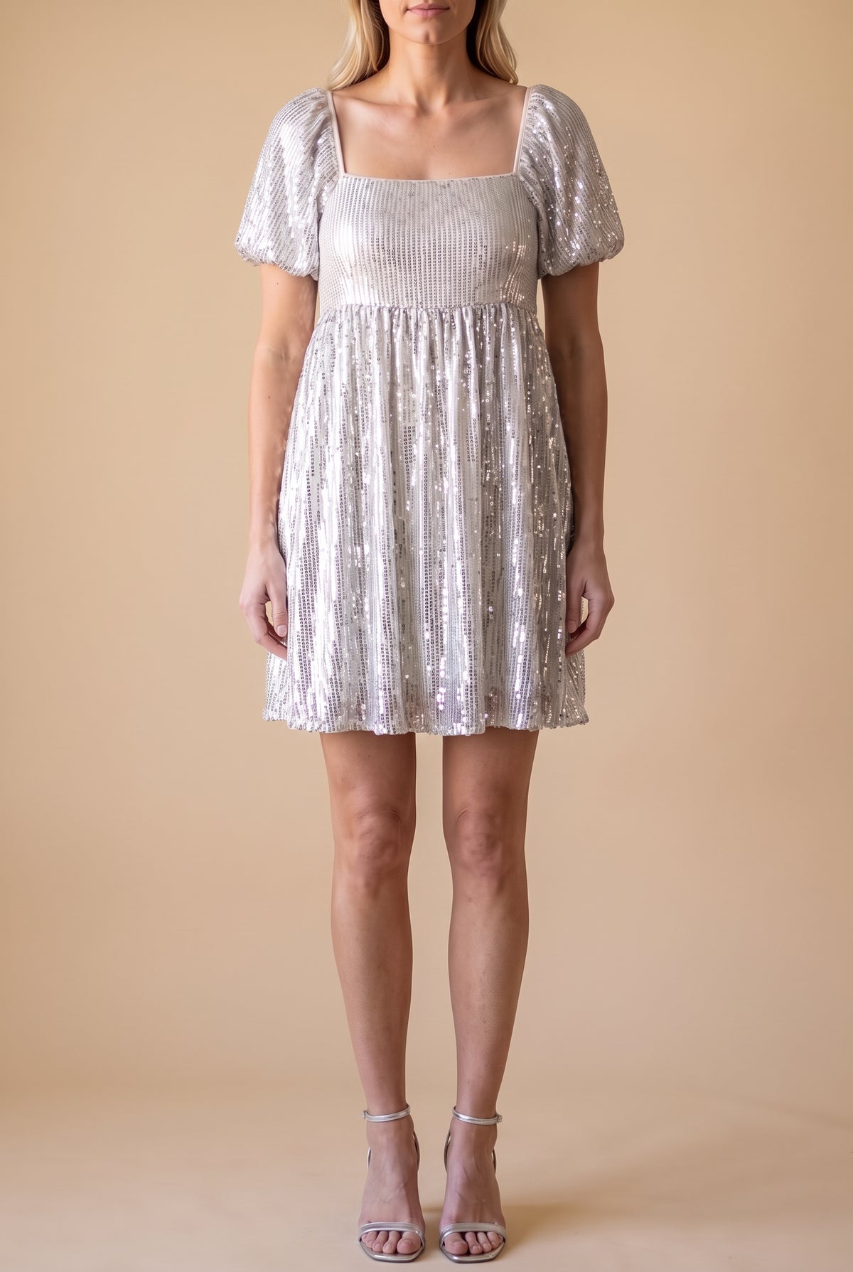 Front view of the Is It Over Now babydoll dress in ivory chiffon with silver sequin stripes, square neckline and puff sleeves