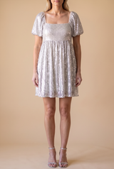 Front view of the Is It Over Now babydoll dress in ivory chiffon with silver sequin stripes, square neckline and puff sleeves