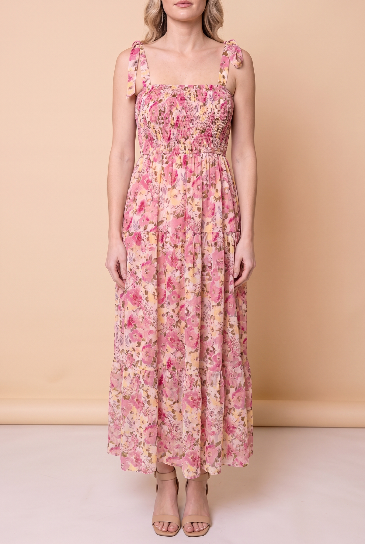Front view of the Enchanted Moments Floral Smocked Maxi Dress: smocked bodice, tie straps and an ankle length tiered skirt.