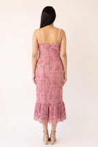 Back view of the pink pearl-trim lace mermaid midi dress showing the pearl straps, center zipper and scalloped flounce