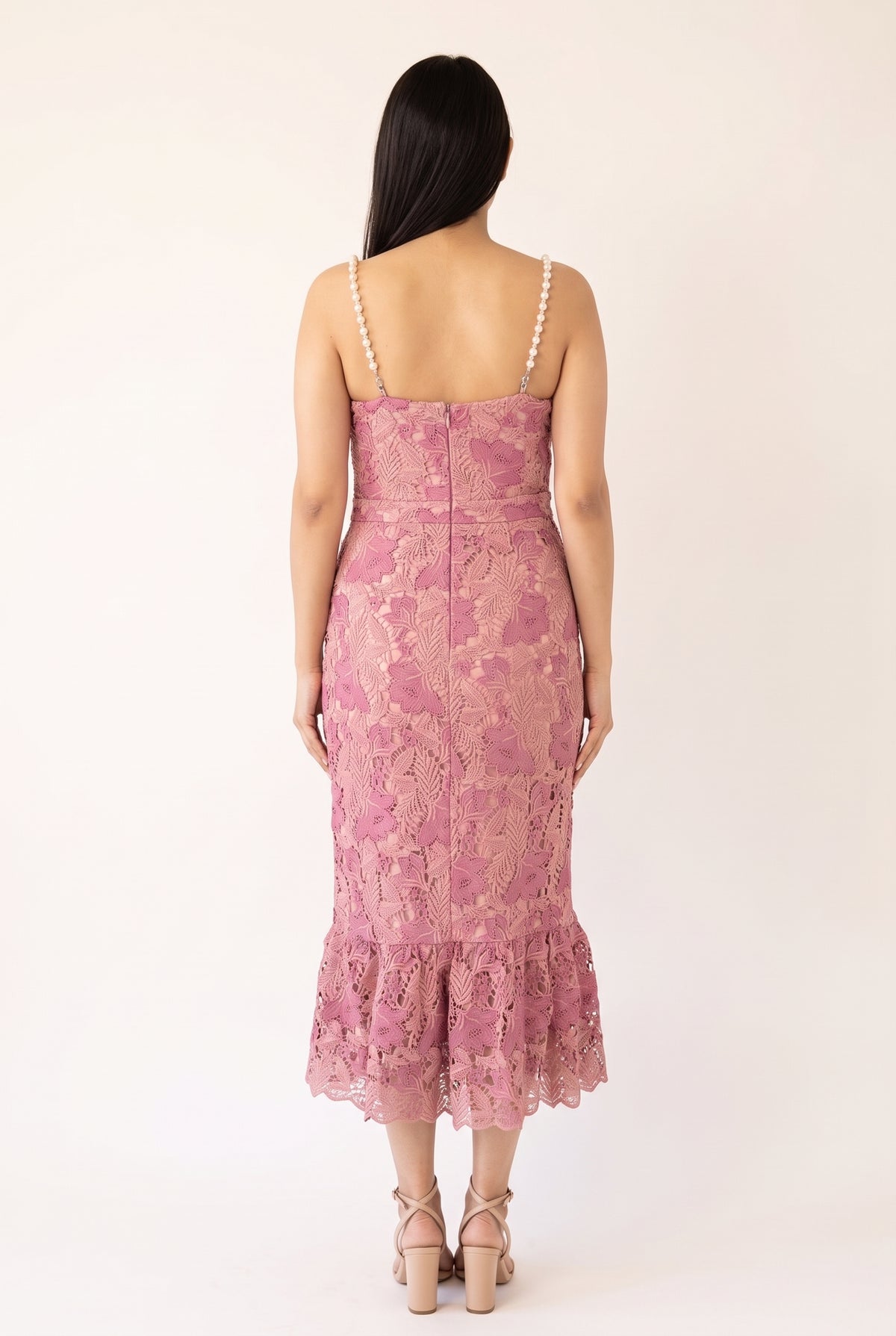 Back view of the pink pearl-trim lace mermaid midi dress showing the pearl straps, center zipper and scalloped flounce