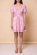 Front view of the Forget Me Not Paisley Dress: pink bandana paisley print, deep V neckline, puff sleeves and a mid-thigh mini skirt.