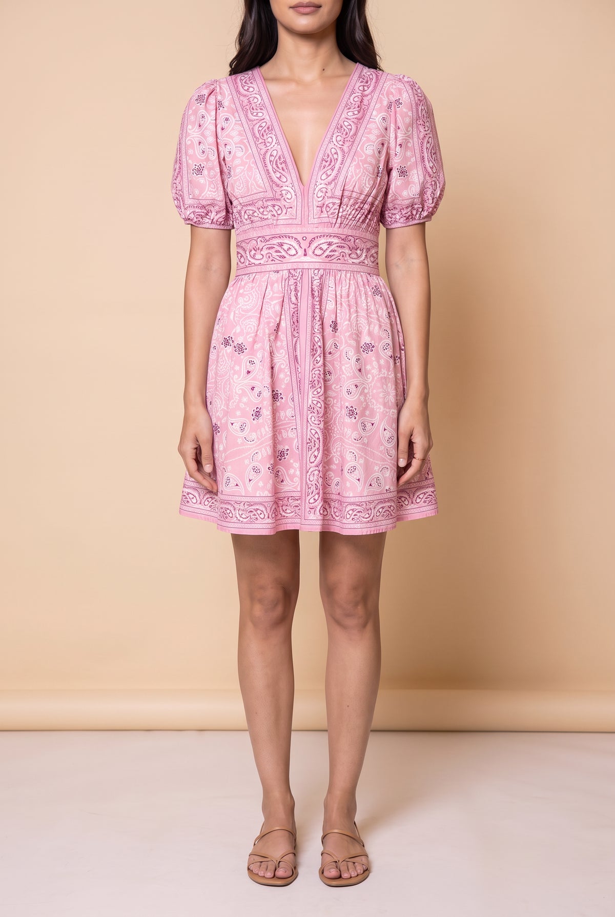 Front view of the Forget Me Not Paisley Dress: pink bandana paisley print, deep V neckline, puff sleeves and a mid-thigh mini skirt.
