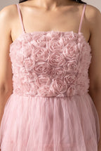 Close detail of the 3D fabric rosettes on the bodice and the gathered blush tulle skirt.