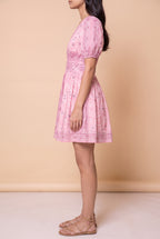 Side view of the Forget Me Not Paisley Dress showing the puff sleeve and full mini skirt.