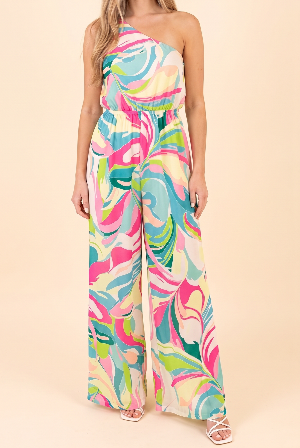 Front of the Style is Self-Expression one-shoulder jumpsuit in a pink, aqua and lime swirl print with elastic waist and wide legs.