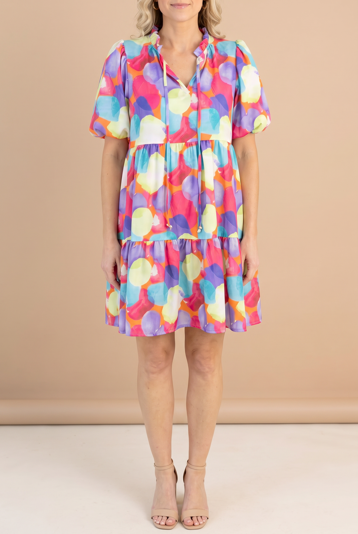 Front of the Crush On You babydoll dress in a watercolor dot print, with ruffled split neck ties, puff sleeves and a ruffle tier hem.