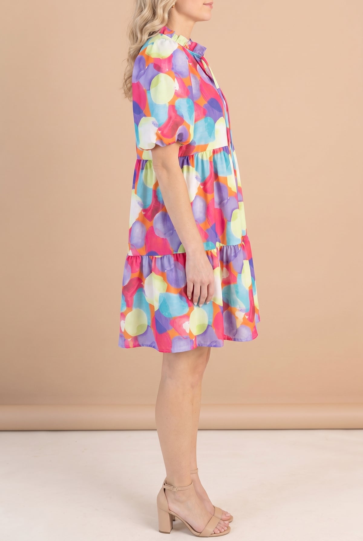 Side of the watercolor print babydoll dress showing the empire seam, ruffle tier and above-the-knee hem.