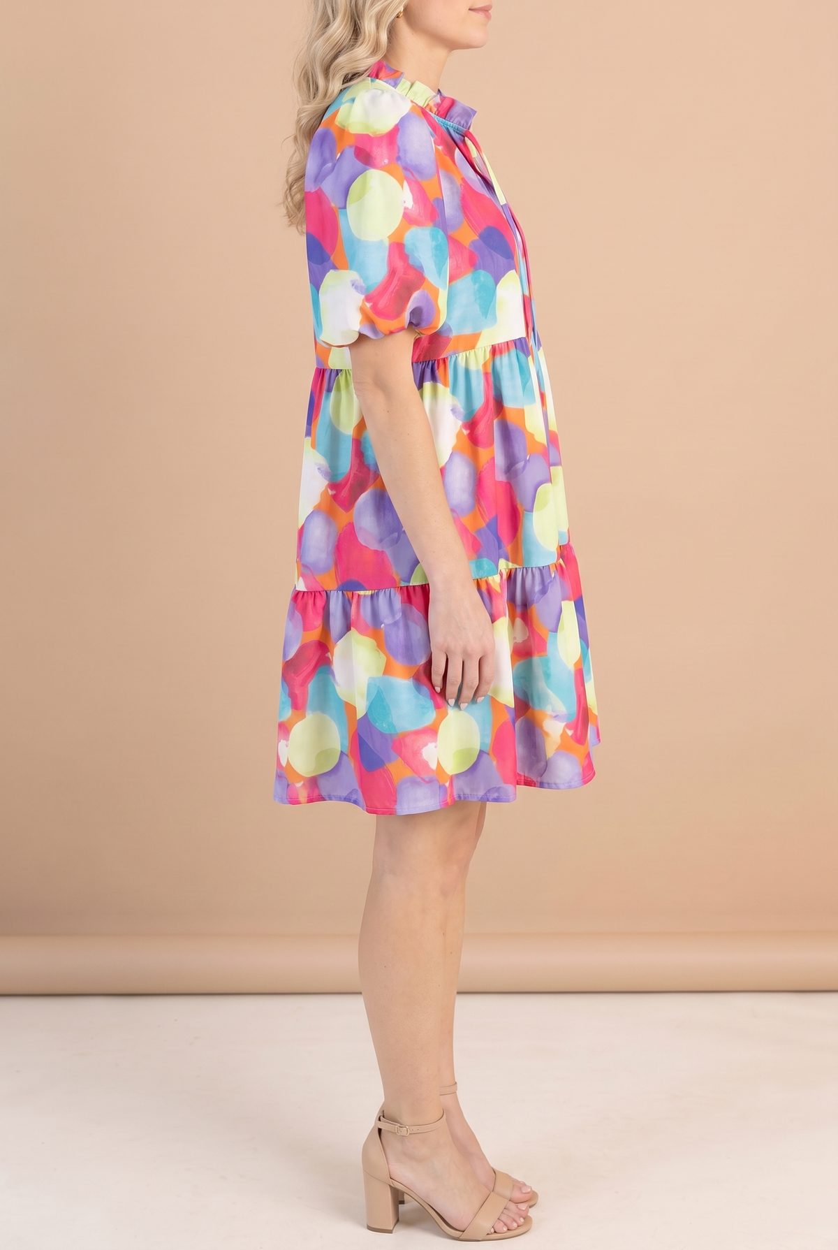Side of the watercolor print babydoll dress showing the empire seam, ruffle tier and above-the-knee hem.