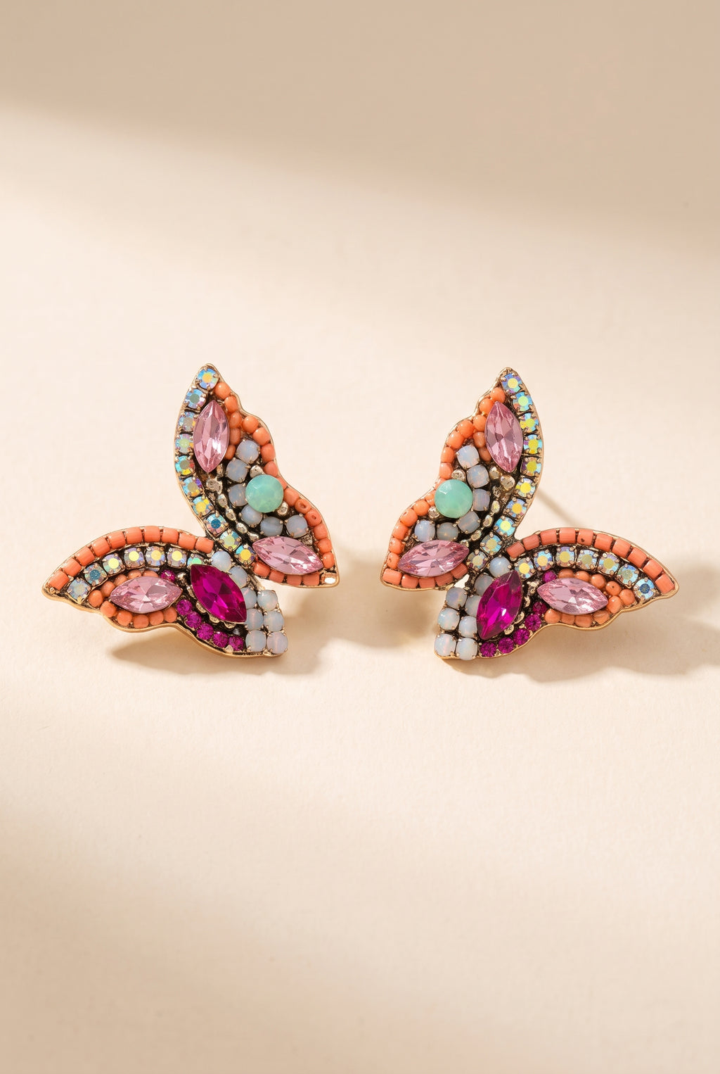 June Butterfly Earrings in Pink: half-butterfly studs with a coral bead border, pink and fuchsia marquise stones, a mint accent stone and AB rhinestones