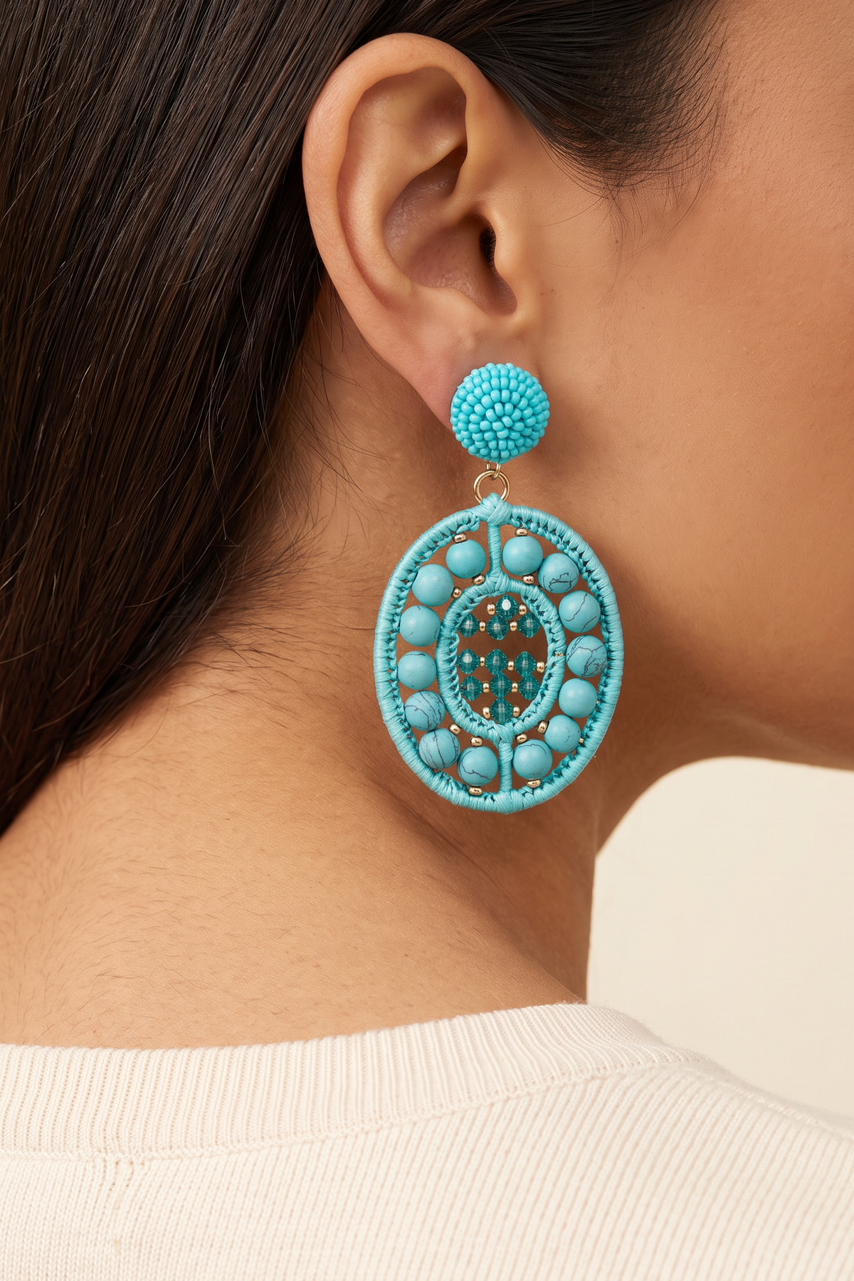 Lauren Aqua Earrings worn on the ear at true size: the oval drop is about 3.5 cm wide and ends near the angle of the jaw