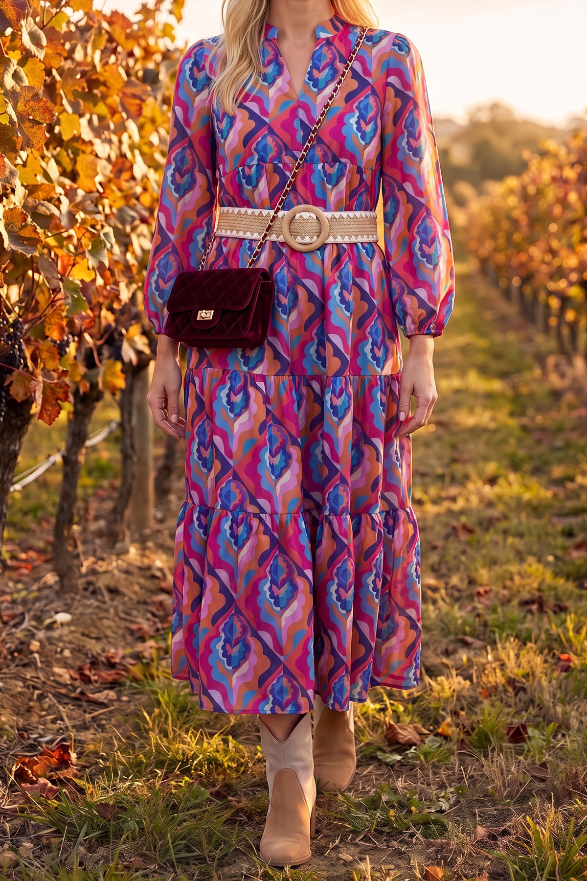 Calling You long sleeve tiered dress styled for fall with Sadie tri-tone booties, the Alora braided belt and the Averie burgundy velvet crossbody in a vineyard.