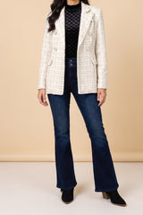 Front view of the Make It Happen cream tweed double-breasted blazer with pearl-look buttons, worn open over a black velvet mock neck top and dark flare jeans.