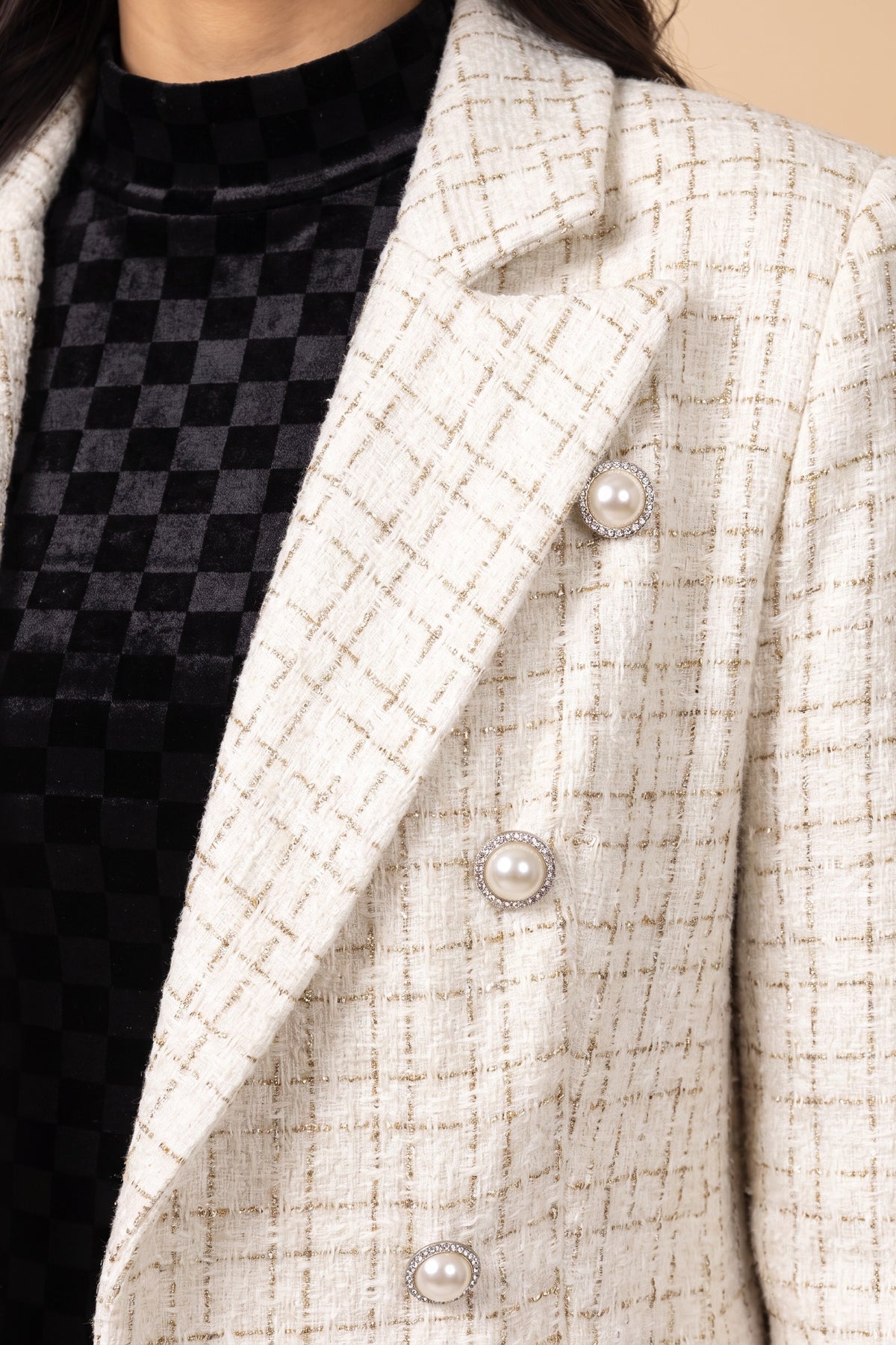 Close-up of the cream boucle tweed, notch lapel and rhinestone-rimmed pearl-look buttons on the Make It Happen Blazer.