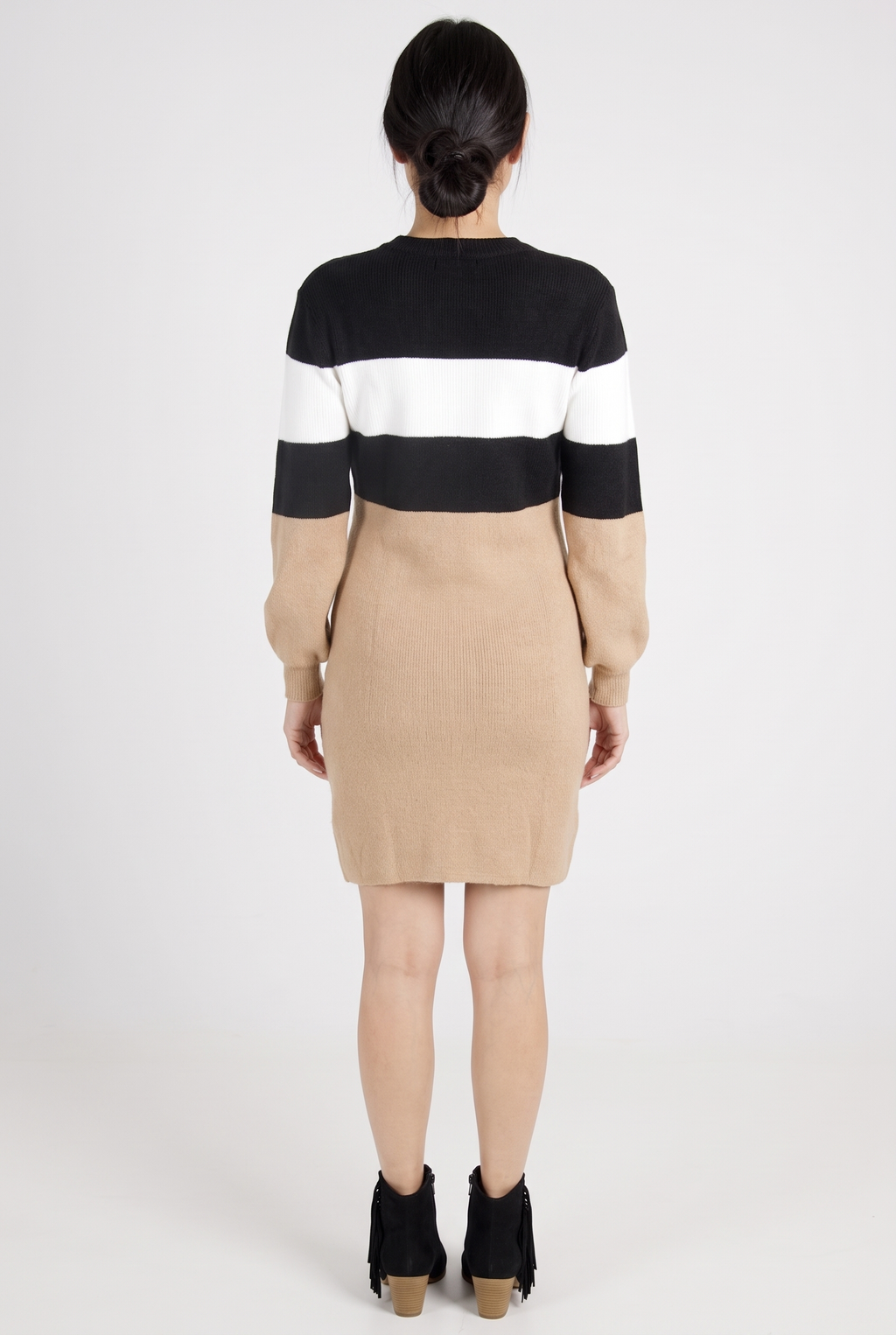 Maverick color block sweater dress, back view, worn by a model on a plain studio backdrop