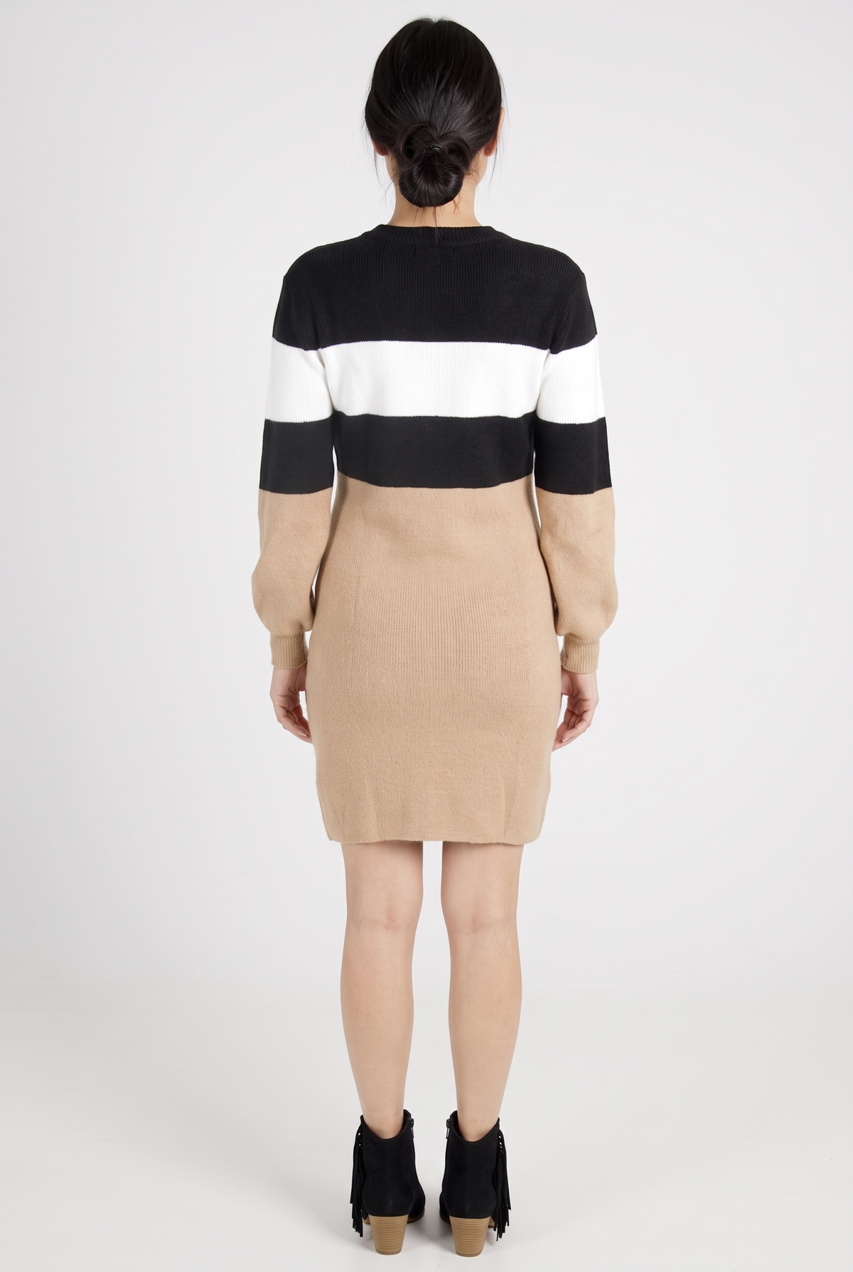 Maverick color block sweater dress, back view, worn by a model on a plain studio backdrop