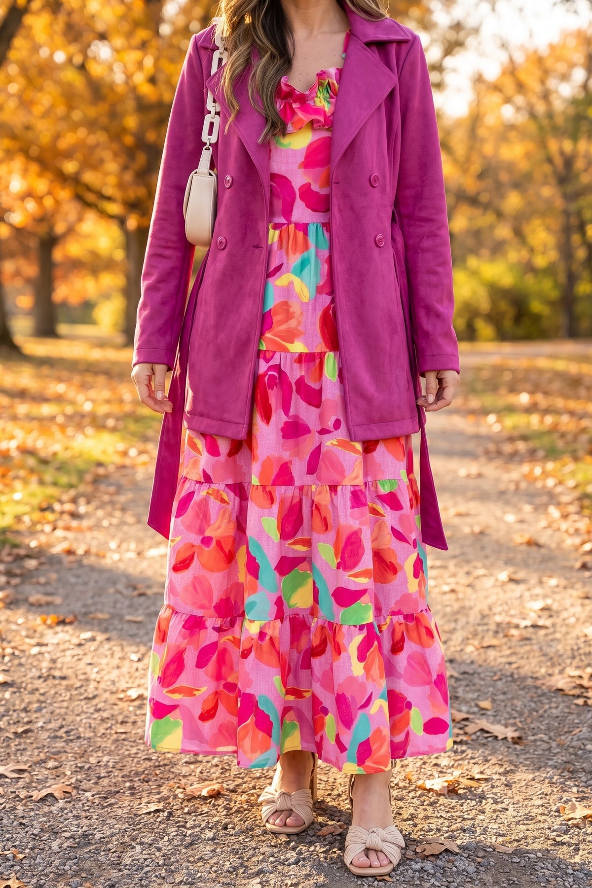 Blooming Affair floral maxi dress styled for an autumn park with a magenta faux suede trench coat, nude pleated bow sandals and a cream chain shoulder bag.