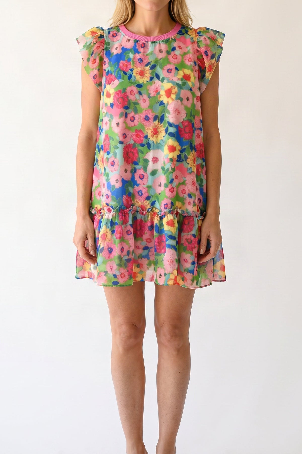 Model wearing the bright floral flutter-sleeve mini dress, shown from the chin down