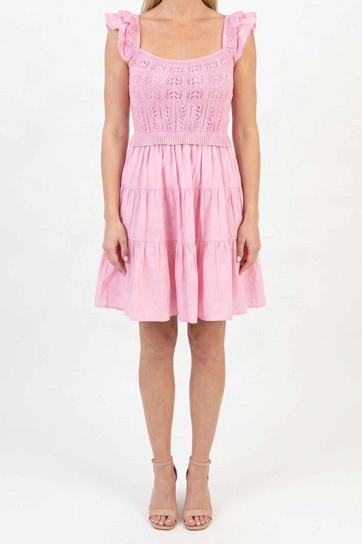 Model wearing the light pink crochet A-line dress, shown from the chin down