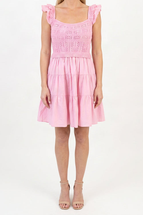 Model wearing the light pink crochet A-line dress, shown from the chin down