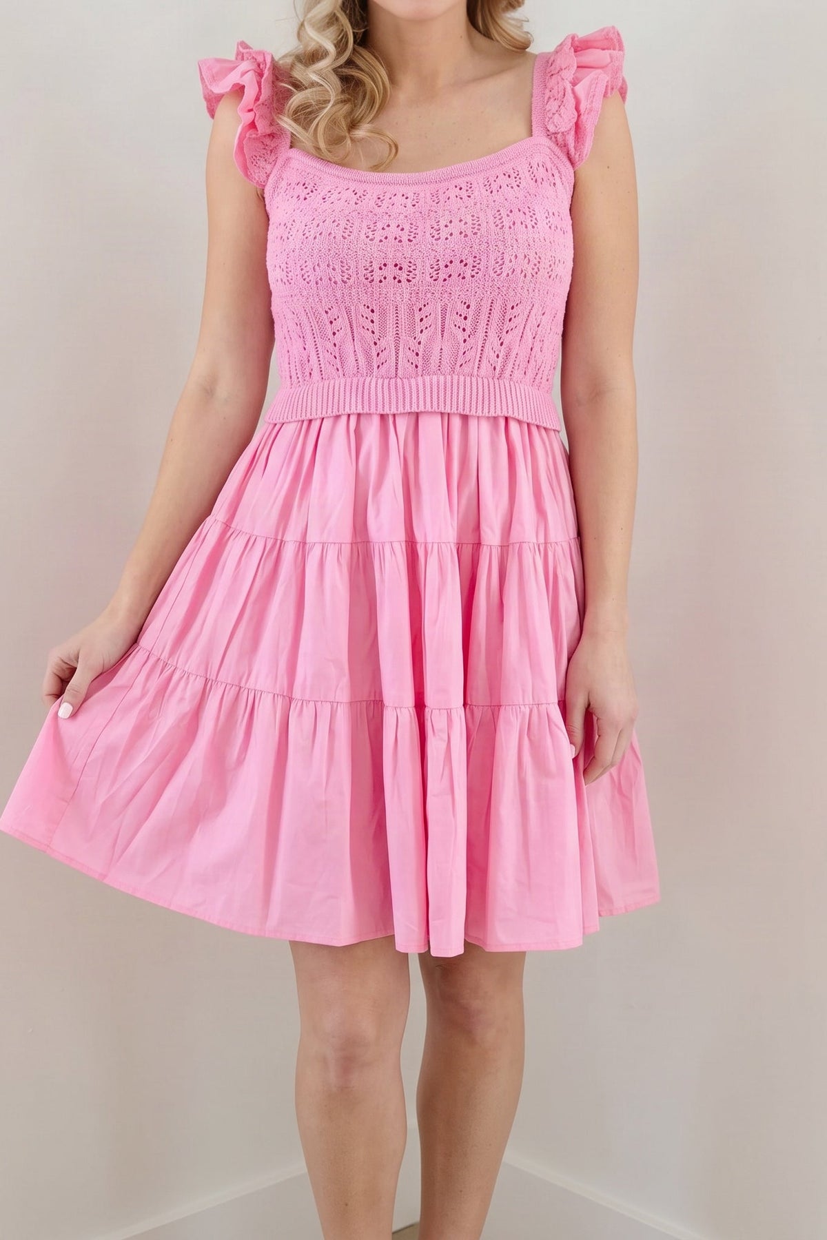 Model wearing the light pink crochet A-line dress, shown from the chin down